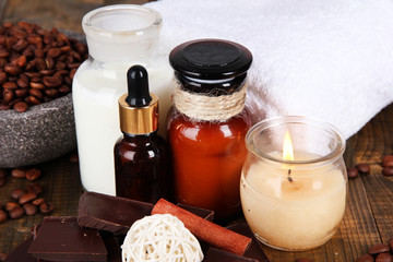 Beautiful chocolate spa setting on wooden table close-up