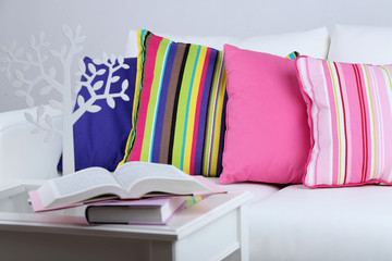 White sofa with colorful pillows in room
