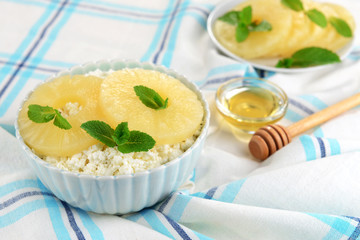 Bowl of tasty cottage cheese with pineapple, close up