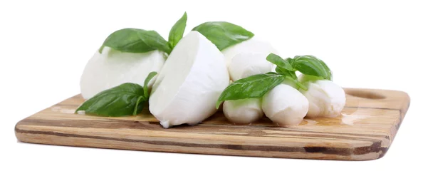 Fotobehang Tasty mozzarella with basil on wooden board isolated on white © Africa Studio