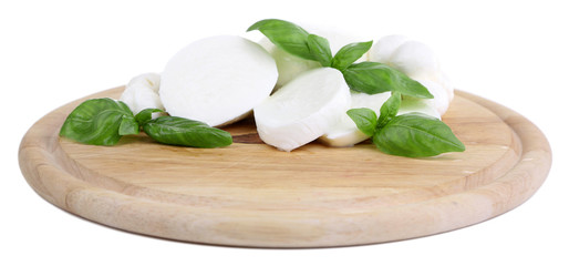 Tasty mozzarella with basil on wooden board isolated on white © Africa Studio