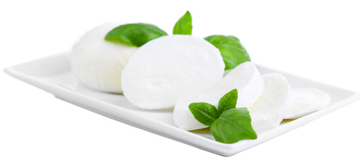 Tasty mozzarella cheese with basil on plate isolated on white © Africa Studio