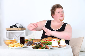 Fat man  do not want to eat a lot of unhealthy food, © Africa Studio
