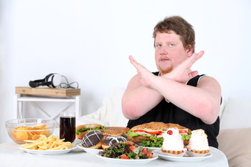 Fat man  do not want to eat a lot of unhealthy food,
