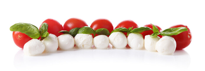 Tasty mozzarella cheese balls with basil and red tomatoes,