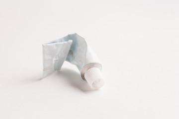 Crumpled tube of glue