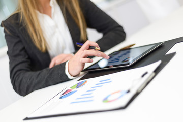 Businesswoman with tablet computer in the office