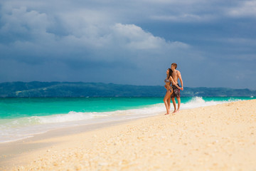 Fototapeta na wymiar young loving happy couple on tropical beach