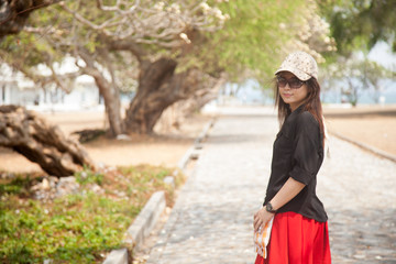 Asian women black shirt Standing on a walkway