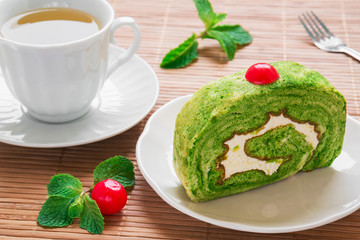 Green tea roll cake and tea cup