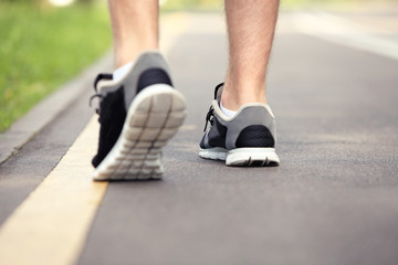 Runner feet running on road closeup on shoe 