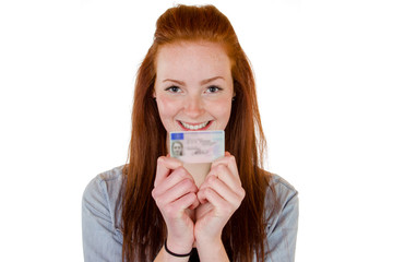 Young woman showing her driver's license - 63799232