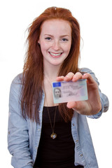 Young woman showing her driver's license - 63799299