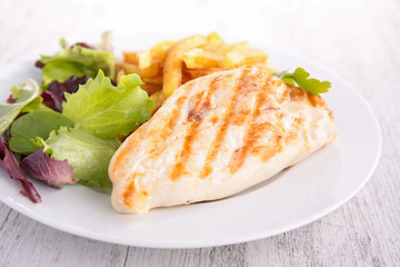 chicken breast with fries and salad