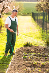 Portrait of a handsome senior man gardening in his garden