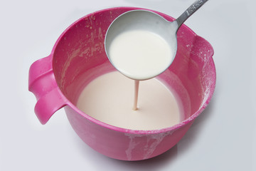 Panncake batter in a bowl with a ladle