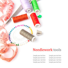 Sewing tools, thread, scissors, pins and measure type on white