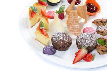 Plate of different desserts isolated