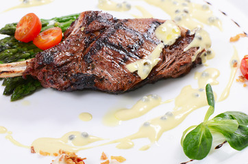 rack of lamb on grill with an asparagus