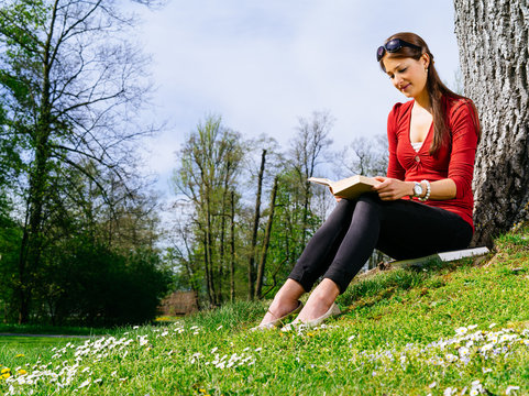 Woman Reading Outside In Spring