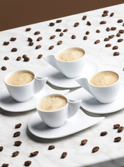 four cups of coffee with milk