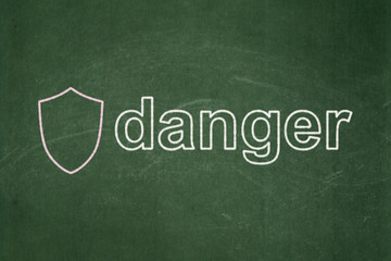 Fototapeta na wymiar Security concept: Shield and Danger on chalkboard background
