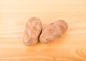 Two Potatoes on a Wood Table