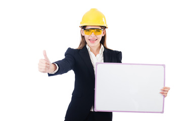 Pretty businesswoman with hard hat and blank board   isolated on
