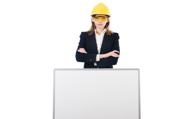 Young businesswoman with hard hat and  blank board isolated on w