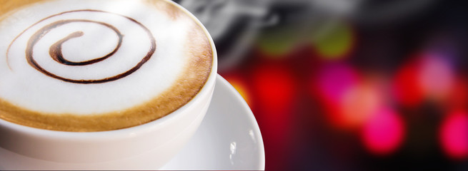 Coffee cup and saucer on bokeh background