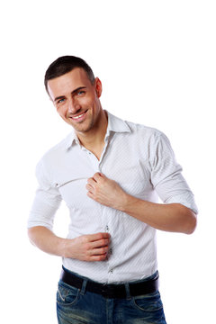 Handsome smiling man standing over white background