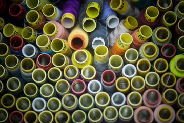 many colorful spools of thread for sewing background