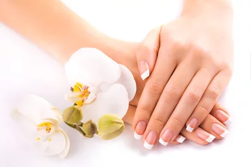 Foto op Canvas beautiful french manicure with white orchid on white © Dmytro Titov