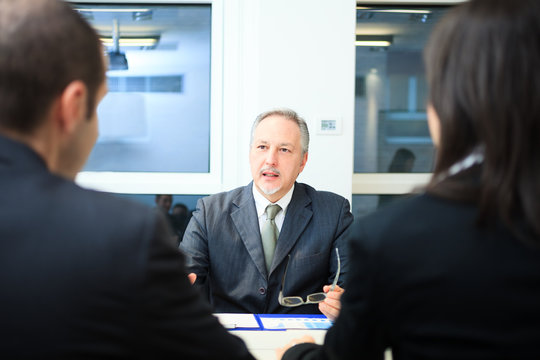 Businessman talking to a couple