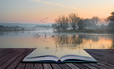 Book concept Landscape of lake in mist with sun glow at sunrise
