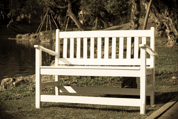 White wooden bent near lake,vintage style light.