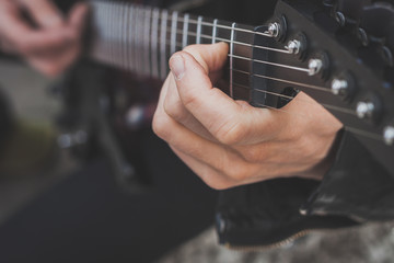 Detail of fingers playing electric guitar