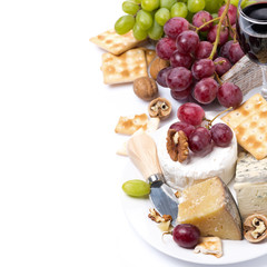 assortment of cheeses, glass of red wine, grapes and crackers