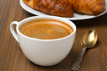 cup of coffee and fresh croissants, selective focus