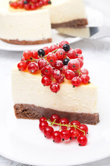 piece of cheesecake decorated with red and black currants