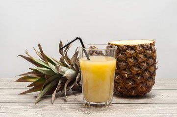 Half-cut pineapple on wooden board