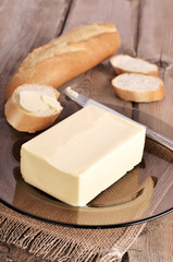 Butter and bread on wooden table