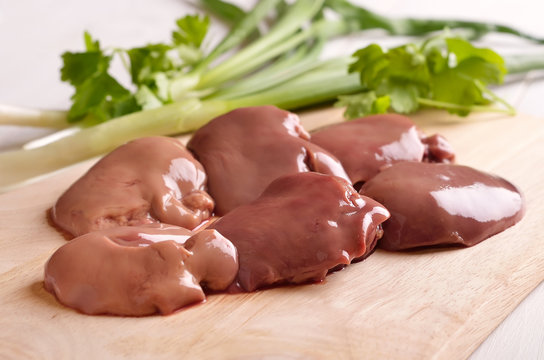 Raw chicken liver on cutting board