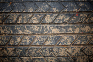 Used grunge crack car tire with brown dirt
