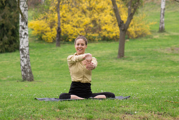 Streching girl in park and smile