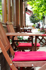 Fototapeta na wymiar Wooden tables at the street cafe