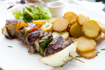 tasty grilled meat and vegetables skewers