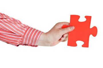 male hand holding big red paper puzzle piece