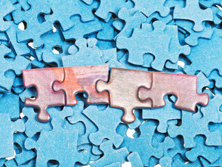 connected pieces on pile of blue jigsaw puzzles