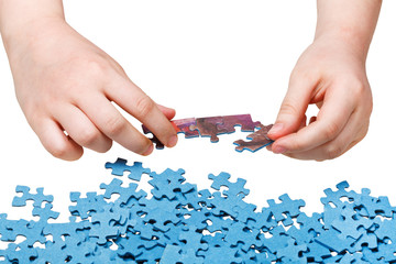 assembling of jigsaw puzzles isolated - obrazy, fototapety, plakaty